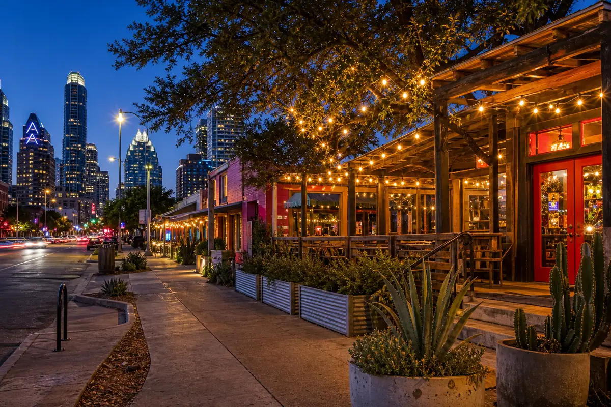 Photoreal Rainey Street nightlife scene with bungalow patios and downtown Austin skyline at blue hour