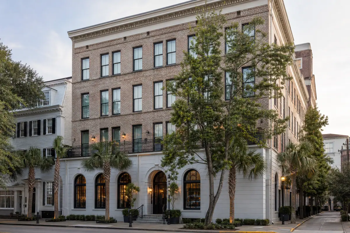 Photoreal entrance and courtyard view of Emeline with greenery and boutique Charleston styling