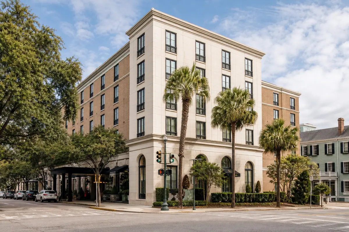 Photoreal exterior of Hampton Inn Charleston-Historic District with brick facade and palm-lined entrance