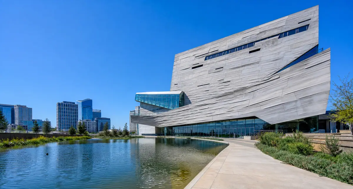Photoreal AT&T Discovery District plaza in Dallas at blue hour with contemporary architecture