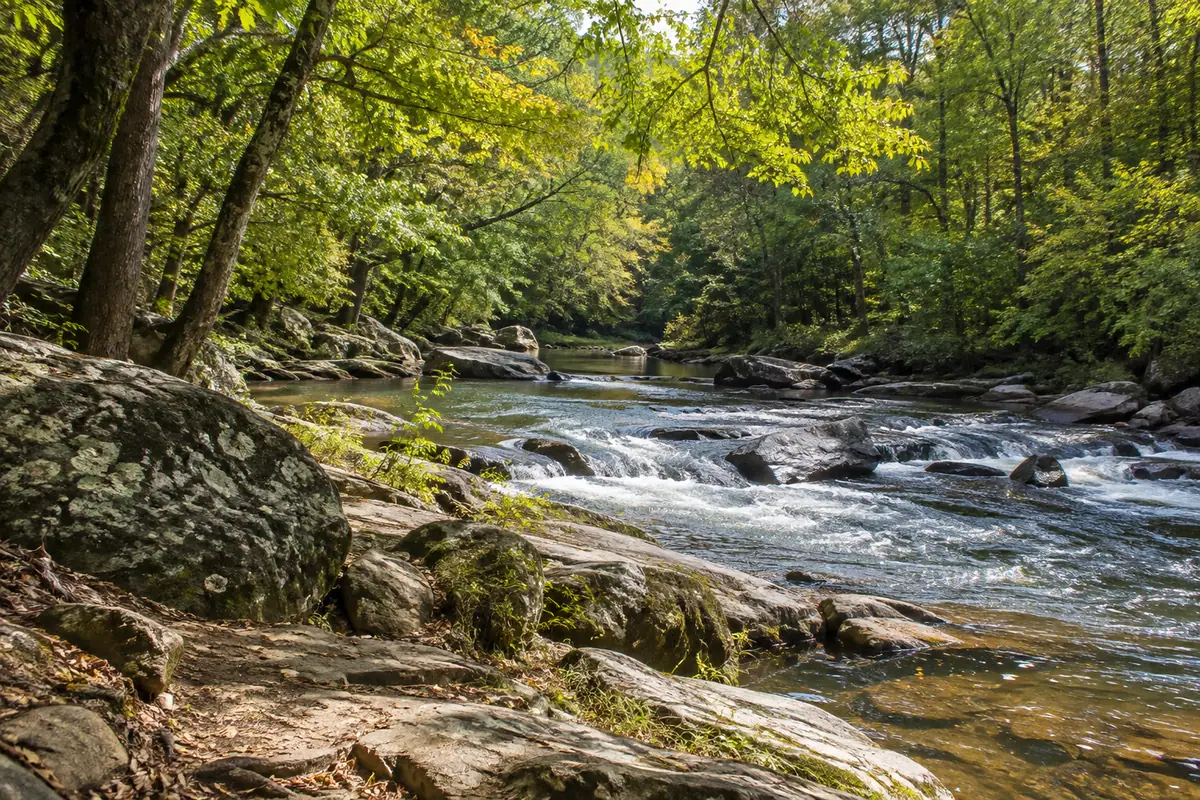Photorealistic travel-editorial view of Eno River State Park in Durham, North Carolina