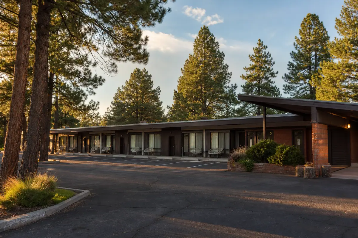 Photoreal travel-editorial exterior of Americana Motor Hotel in Flagstaff, Arizona