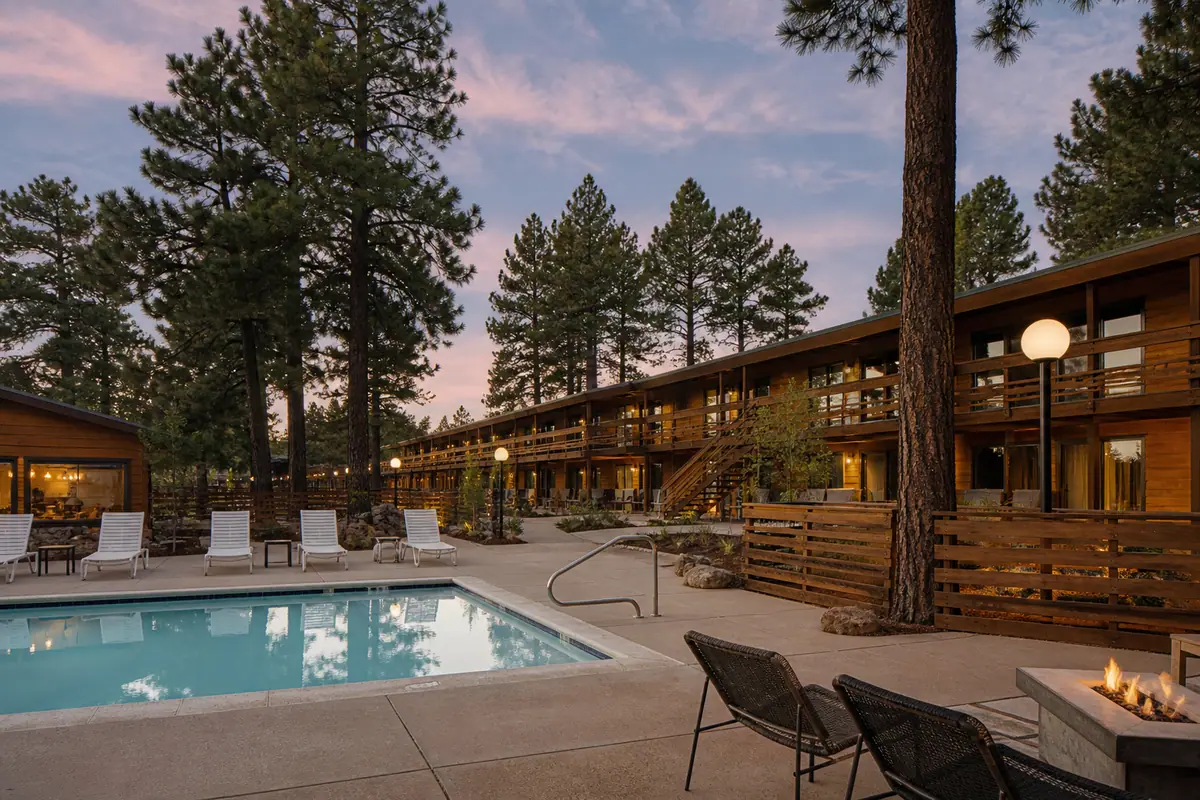 Photoreal travel-editorial exterior of High Country Motor Lodge in Flagstaff, Arizona