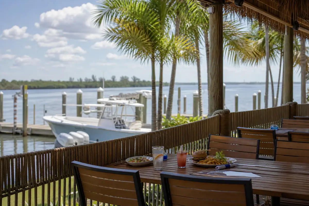 Photoreal travel-editorial view of The Boathouse Tiki Bar & Grill in Fort Myers, Florida