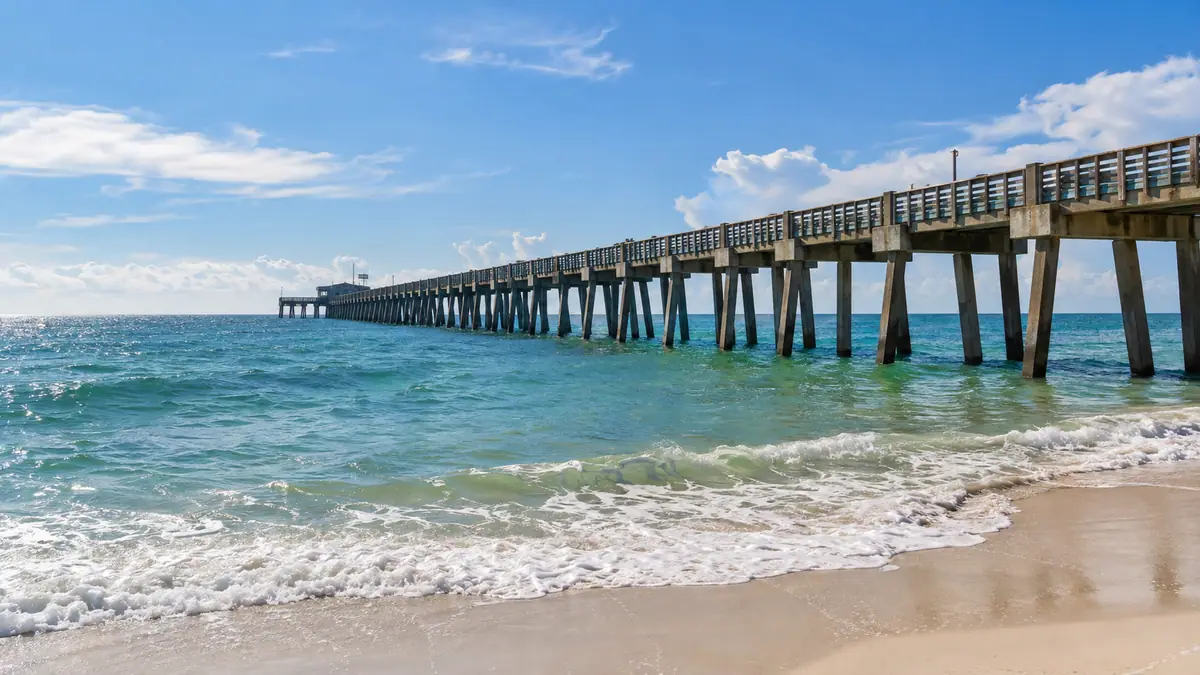 Photoreal travel-editorial view of Gulf State Park Pier in Gulf Shores, Alabama