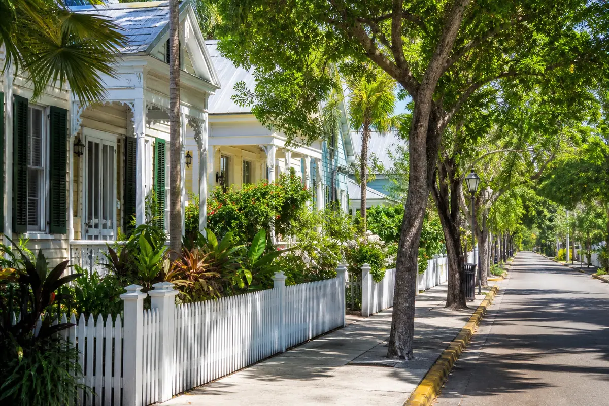 Photoreal historic conch houses along a shaded Key West street
