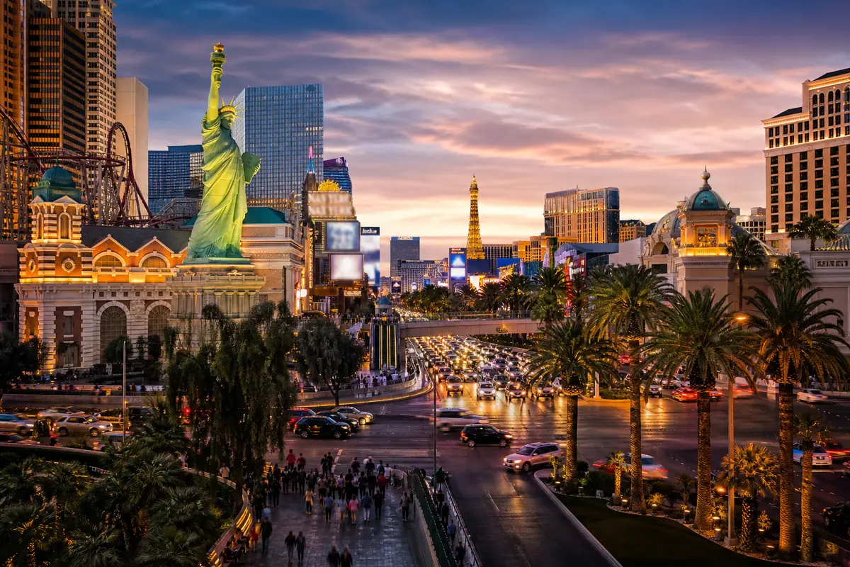 Photoreal Las Vegas Strip resort corridor with landmark hotels and pedestrian energy at dusk