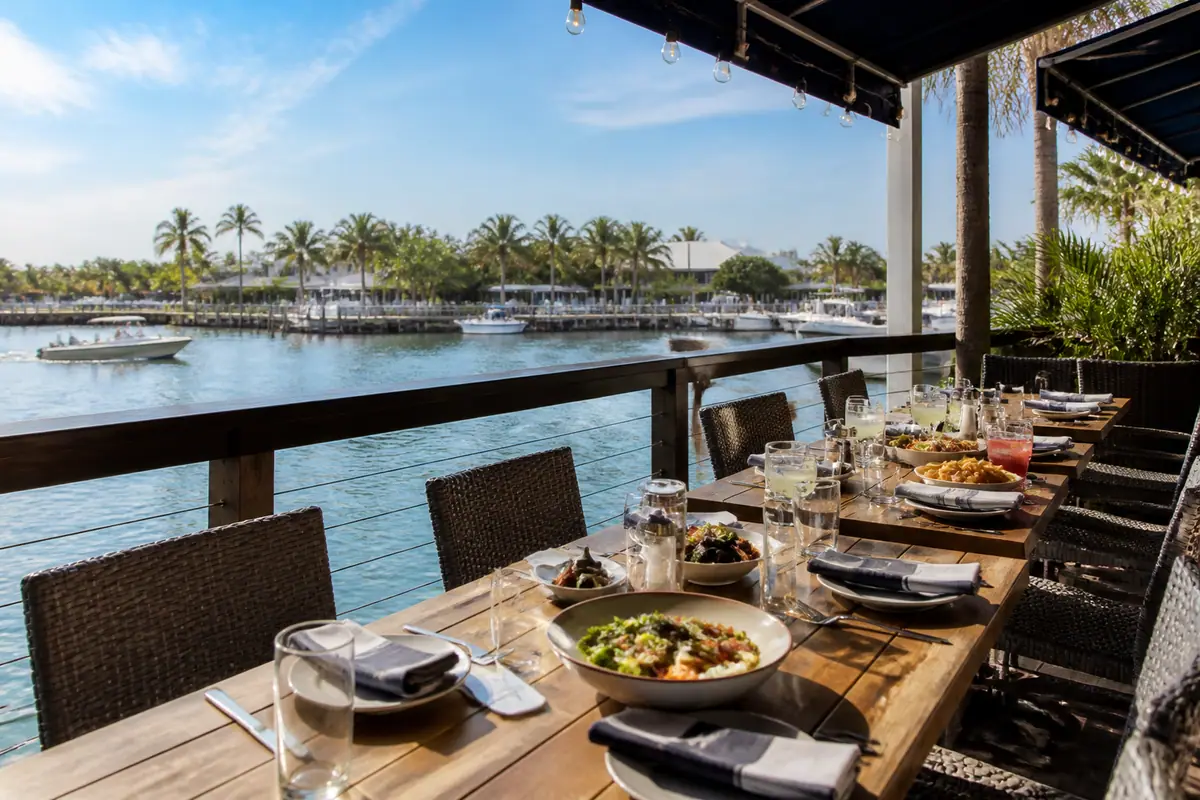 Photoreal travel-editorial view of The Dock at Crayton Cove in Naples, Florida