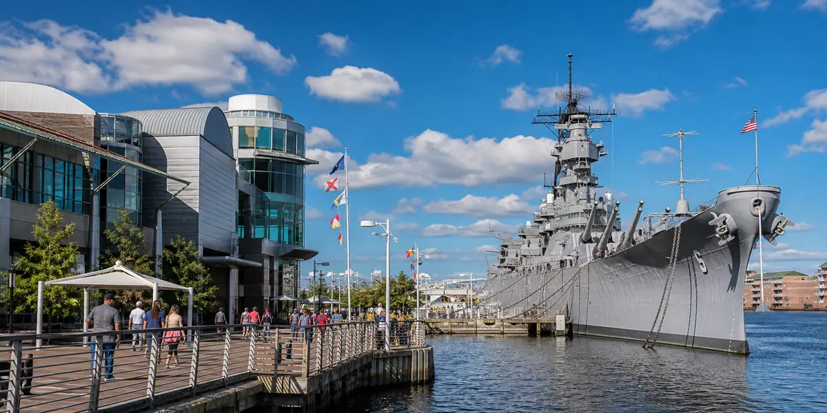 Photoreal harborfront battleship scene representing Nauticus and Battleship Wisconsin in Norfolk