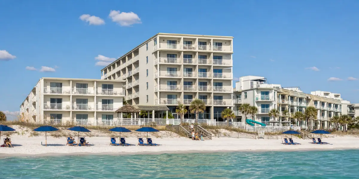 Photoreal family-friendly beachfront resort exterior representing Sandpiper Beacon Beach Resort