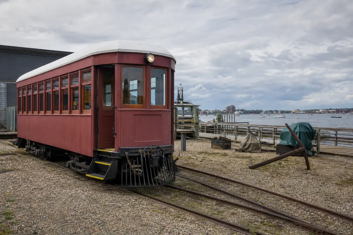 Photoreal travel-editorial view of Maine Narrow Gauge Railroad Museum in Portland, Maine