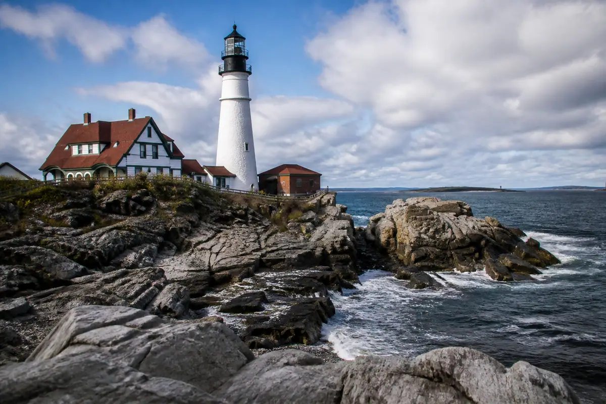 Photoreal travel-editorial view of Portland Head Light in Portland, Maine