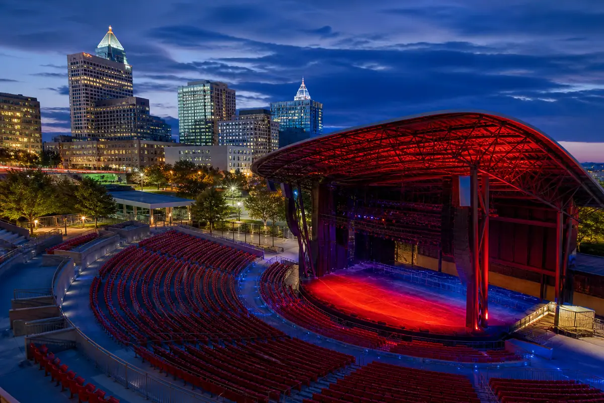 Photorealistic travel-editorial view of Red Hat Amphitheater Performance in Raleigh, North Carolina