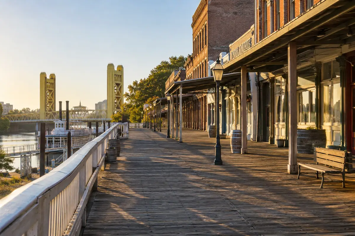 Photorealistic travel-editorial view of Old Sacramento Waterfront in Sacramento, California