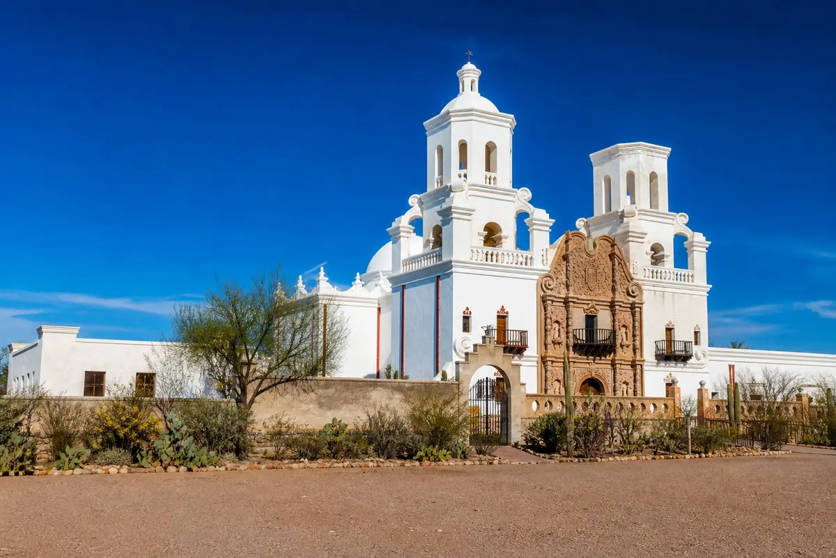 Photoreal travel-editorial view of Mission San Xavier del Bac in Tucson, Arizona