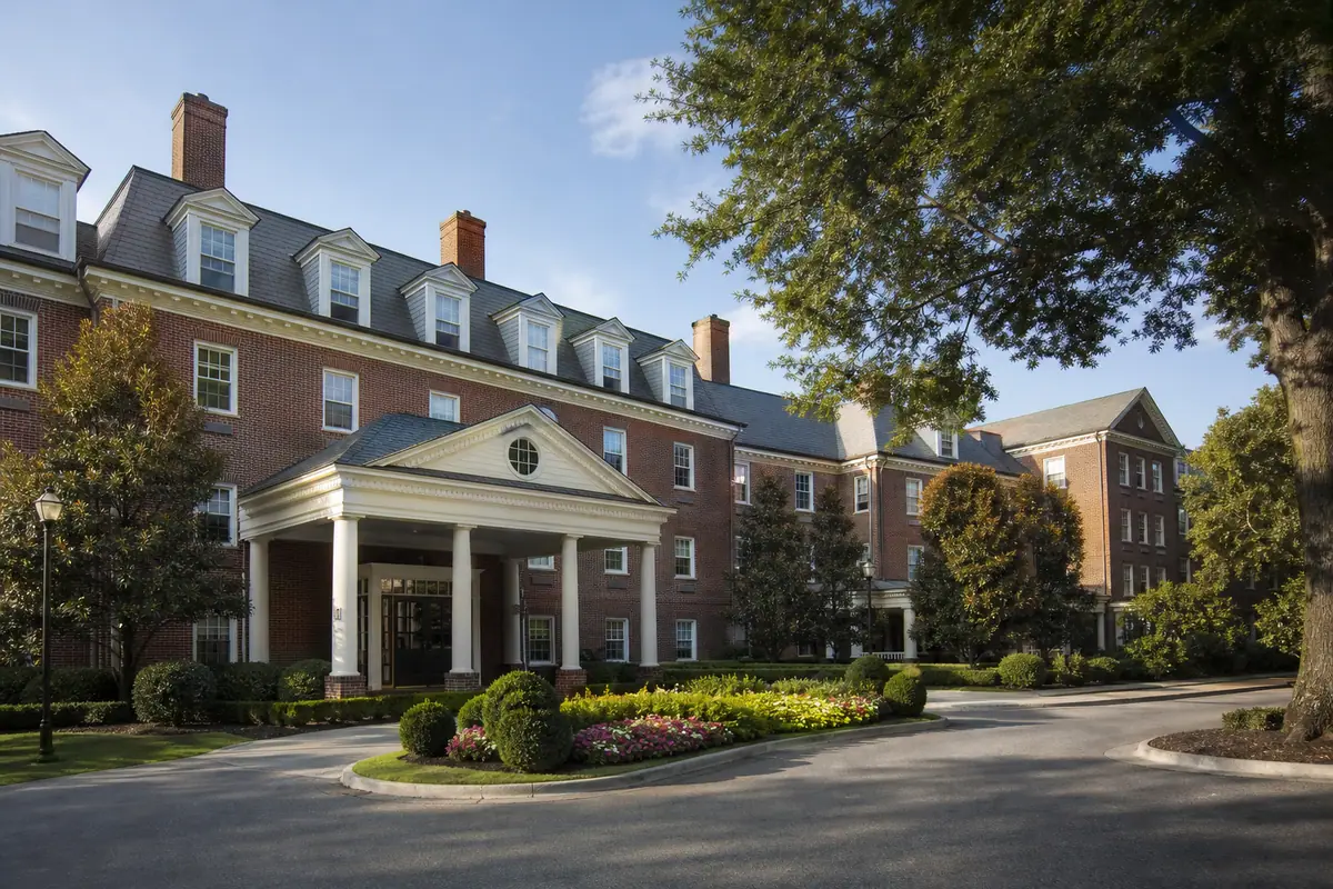 Photoreal family-friendly hotel exterior representing Williamsburg Woodlands Hotel & Suites